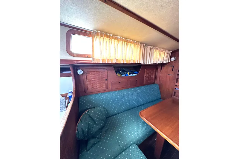 Slide: The Image of Interior of a 1984 Sabre 38 yacht with cozy seating area. - 44