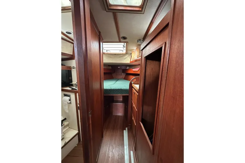 Slide: The Image of Interior of 1984 Sabre 38 sailboat with wooden cabinetry and cozy sleeping area. - 47