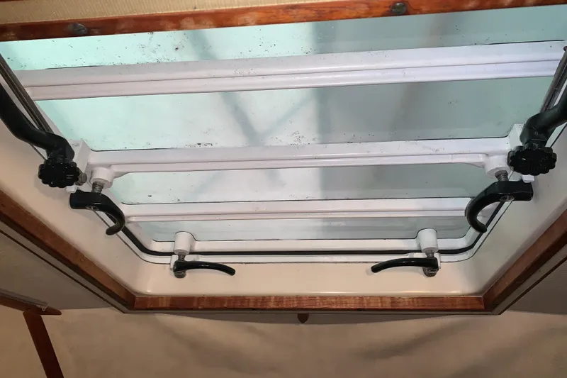 Slide: The Image of 1984 Sabre 38 hatch with metal frame and locking mechanisms. - 49