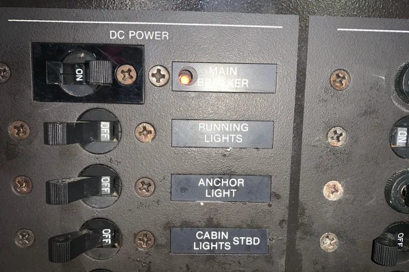 Slide: The Image of Control panel of a 1984 Sabre 38 with switches for lights and main breaker. - 54
