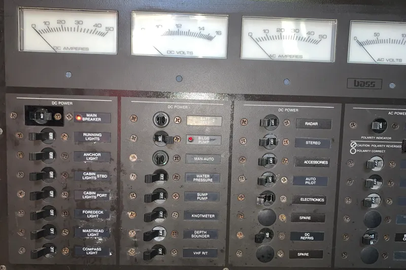 Slide: The Image of Electrical control panel of a 1984 Sabre 38 boat with various switches and gauges. - 55