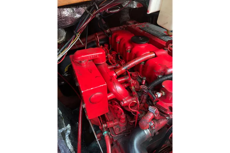 Slide: The Image of Red engine of a 1984 Sabre 38 sailboat with visible wiring and components. - 58