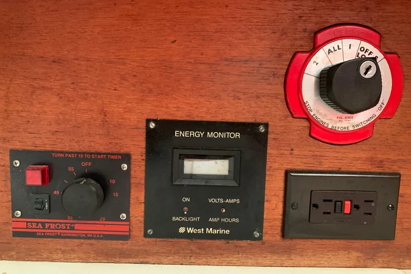 Slide: The Image of Control panel on a 1984 Sabre 38 boat with energy monitor and switches. - 59