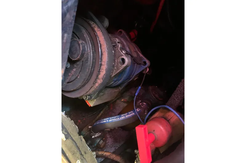 Slide: The Image of Engine compartment of a 1984 Sabre 38 sailboat, showing mechanical components and wiring. - 60