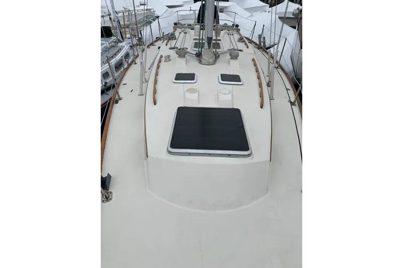 Slide: The Image of 1984 Sabre 38 sailboat deck with hatches and rigging, docked in a marina. - 65