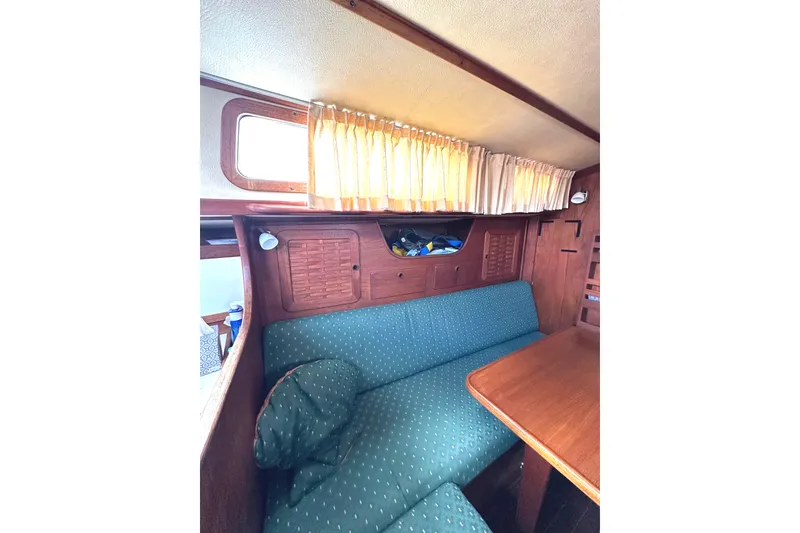 Slide: The Image of Interior of a 1984 Sabre 38 yacht with cozy seating area. - 8
