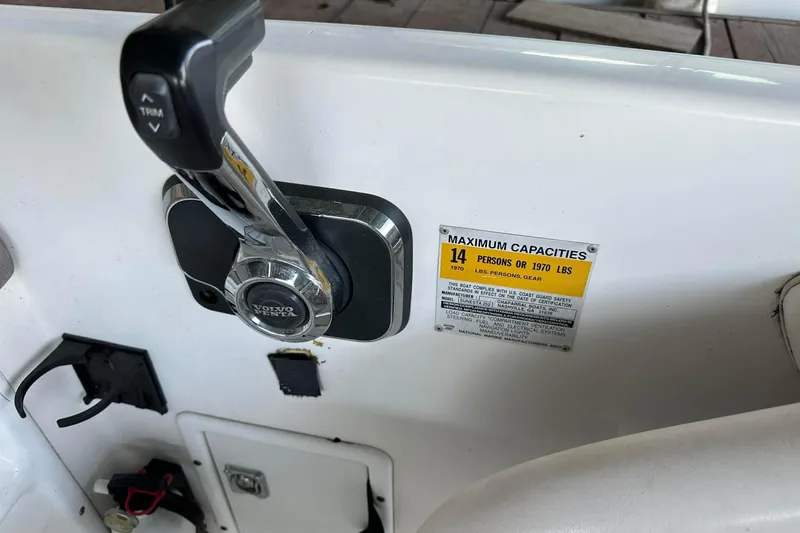 Slide: The Image of 1998 Chaparral Sunesta 252 boat control panel with capacity label and Volvo Penta throttle. - 10