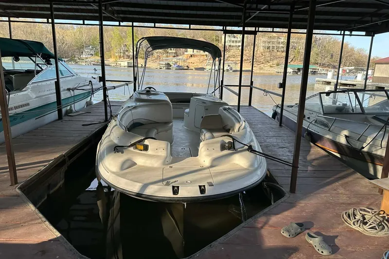Slide: The Image of 1998 Chaparral Sunesta 252 boat docked in a marina, surrounded by other boats. - 14
