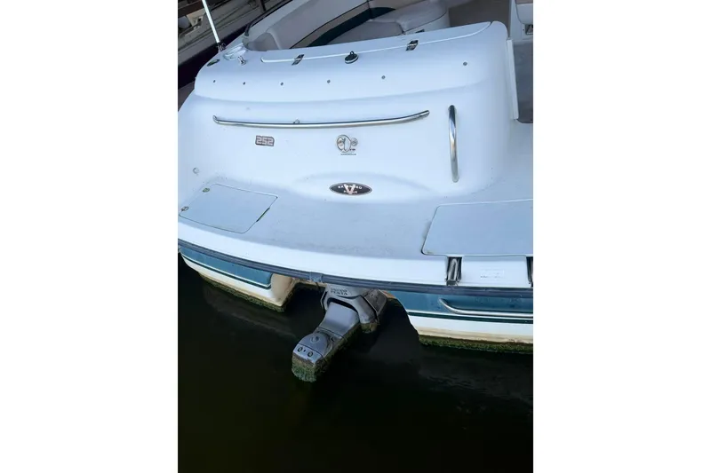 Slide: The Image of 1998 Chaparral Sunesta 252 boat stern view with outboard motor in water. - 20