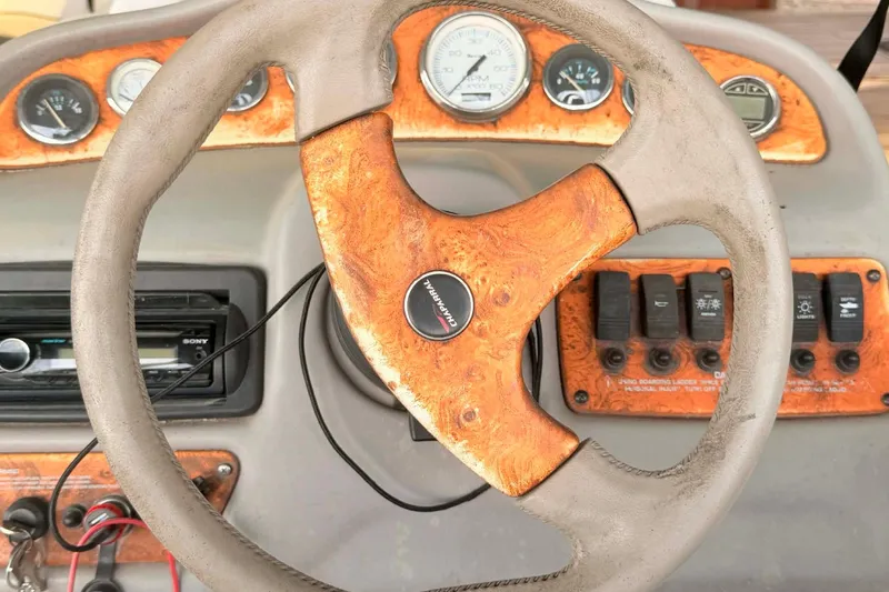 Slide: The Image of Steering wheel and dashboard of a 1998 Chaparral Sunesta 252 boat. - 5