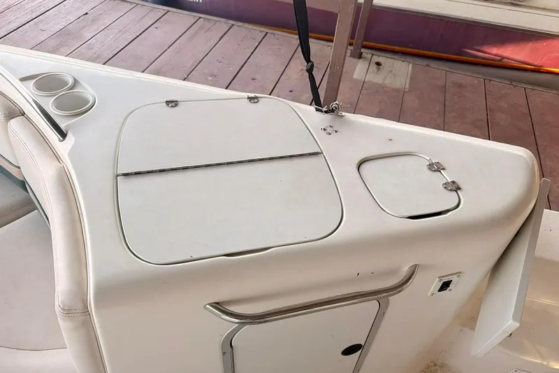 Slide: The Image of 1998 Chaparral Sunesta 252 boat interior with storage compartments and cup holders. - 6