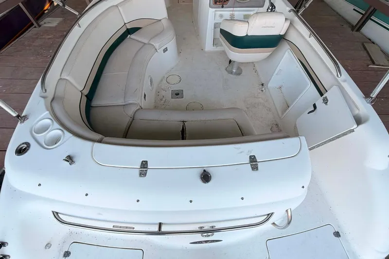 Slide: The Image of 1998 Chaparral Sunesta 252 boat interior with white seating and steering console. - 8