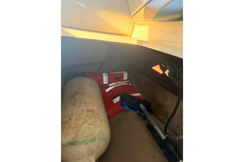 Slide: The Image of Interior storage of 1998 Chaparral Sunesta 252 with life jacket and equipment. - 9