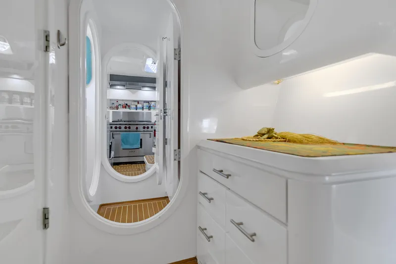 Slide: The Image of Interior of 1988 Kelsall Manannan Custom yacht with modern kitchen and sleek white cabinetry. - 17