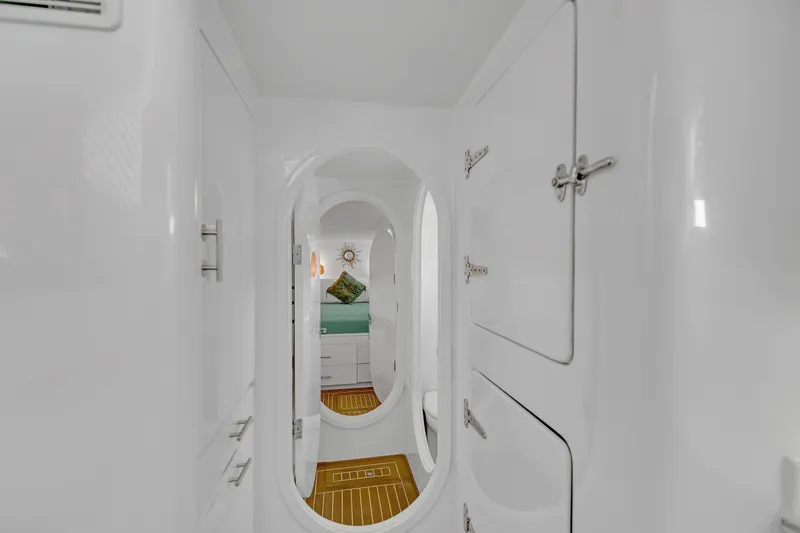 Slide: The Image of Interior of 1988 Kelsall Manannan Custom yacht with sleek white design and wooden flooring. - 18