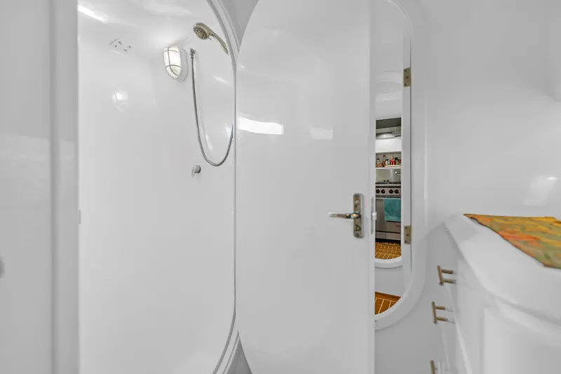 Slide: The Image of Interior of 1988 Kelsall Manannan Custom yacht, featuring a sleek white shower area. - 21