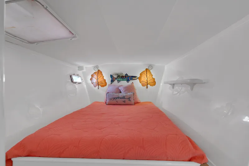 Slide: The Image of Cozy cabin interior of 1988 Kelsall Manannan Custom with vibrant bedding and decorative lighting. - 23