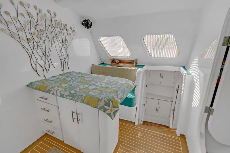 Slide: The Image of Cozy cabin interior of 1988 Kelsall Manannan Custom boat with floral decor and storage. - 26