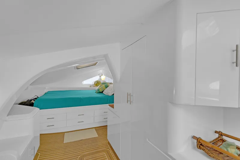 Slide: The Image of Interior of 1988 Kelsall Manannan Custom yacht with cozy bed and modern white cabinetry. - 29