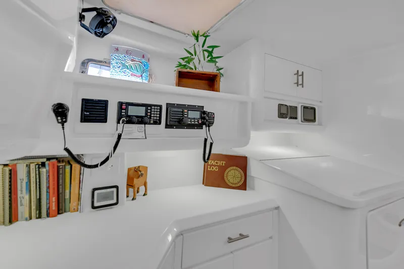 Slide: The Image of Interior of 1988 Kelsall Manannan Custom yacht with navigation equipment and books. - 37