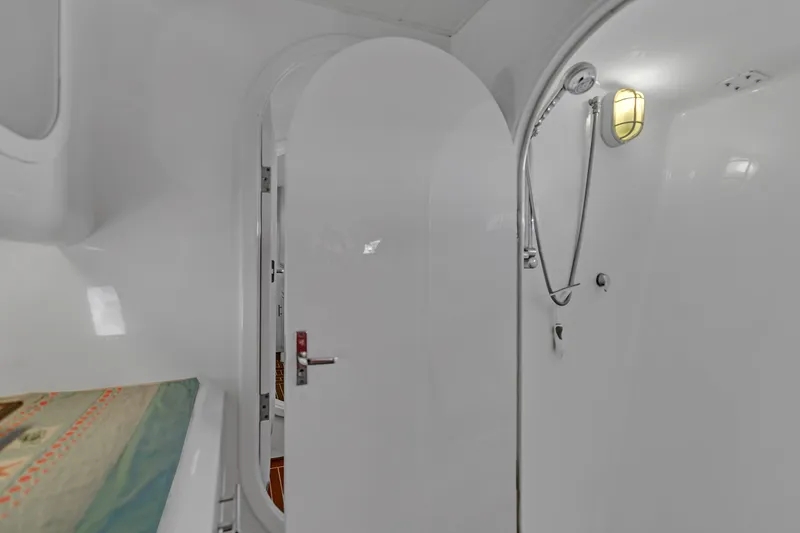 Slide: The Image of Interior of 1988 Kelsall Manannan Custom yacht, featuring a sleek, modern shower area. - 50