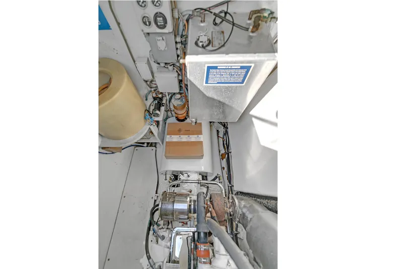 Slide: The Image of Engine room of 1988 Kelsall Manannan Custom boat, showcasing mechanical components and wiring. - 54