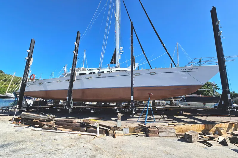 Slide: The Image of Kelsall Manannan 78 Custom yacht from 1988 on dry dock under clear blue sky. - 58