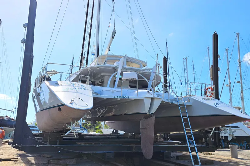 Slide: The Image of Kelsall Manannan 78 Custom catamaran from 1988 in a boatyard, elevated for maintenance. - 60