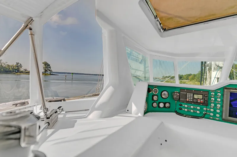 Slide: The Image of Interior view of 1988 Kelsall Manannan Custom yacht cockpit with control panel and scenic waterway. - 7