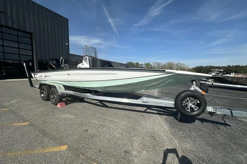 The Image of 2026 Xpress H22B Bay boat on trailer, parked outdoors under clear sky. - 0