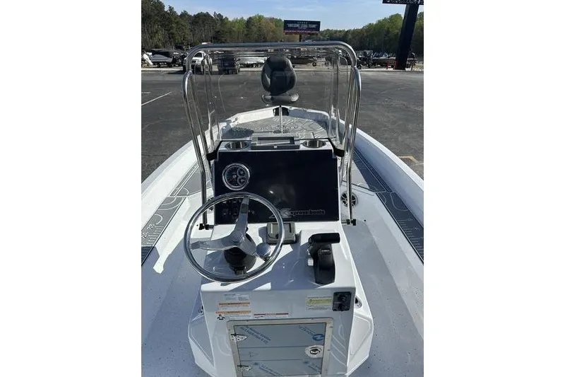 Slide: The Image of 2026 Xpress H22B Bay boat console with steering wheel and controls. - 4
