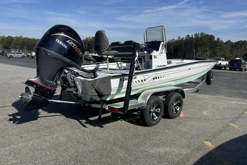 Slide: The Image of 2026 Xpress H22B Bay boat on trailer with Yamaha engine in parking lot. - 7