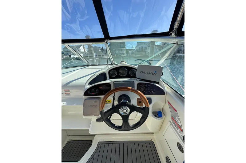 Slide: The Image of 2005 Sea Ray Sundancer 260 helm with Garmin navigation system and wooden steering wheel. - 12