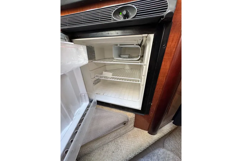 Slide: The Image of Open refrigerator inside 2005 Sea Ray Sundancer 260 boat, showing empty shelves. - 20