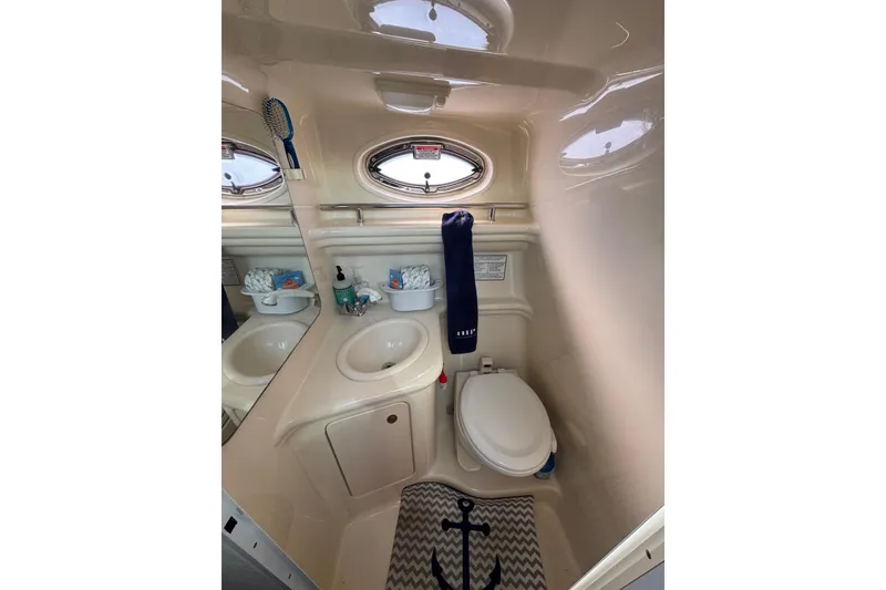 Slide: The Image of 2005 Sea Ray Sundancer 260 bathroom with sink, toilet, and nautical decor. - 23