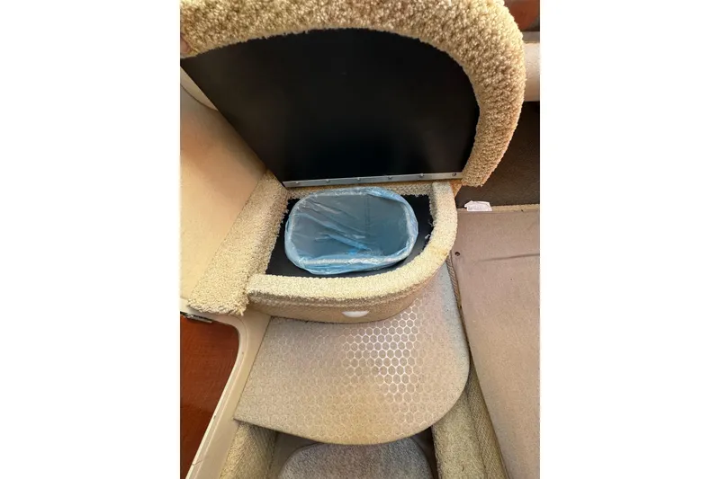 Slide: The Image of Interior storage compartment with trash bin on 2005 Sea Ray Sundancer 260 boat. - 24