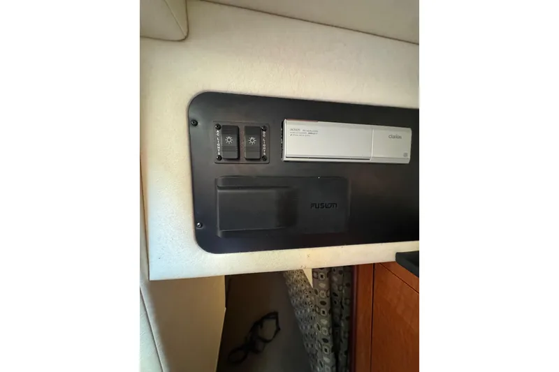 Slide: The Image of Control panel inside 2005 Sea Ray Sundancer 260 boat cabin with switches and Clarion stereo. - 25