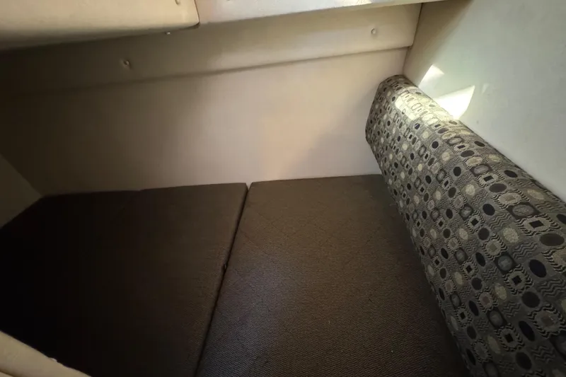 Slide: The Image of Interior cabin of 2005 Sea Ray Sundancer 260 with patterned upholstery and cushions. - 26