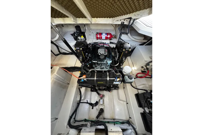 Slide: The Image of Engine compartment of a 2005 Sea Ray Sundancer 260 boat, showcasing detailed components. - 32