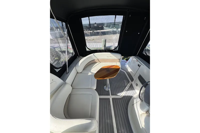 Slide: The Image of 2005 Sea Ray Sundancer 260 interior with white seating and wooden table. - 5