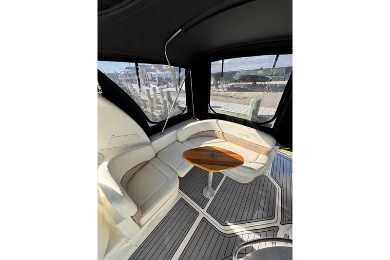Slide: The Image of Interior of 2005 Sea Ray Sundancer 260 with elegant seating and wooden table. - 6