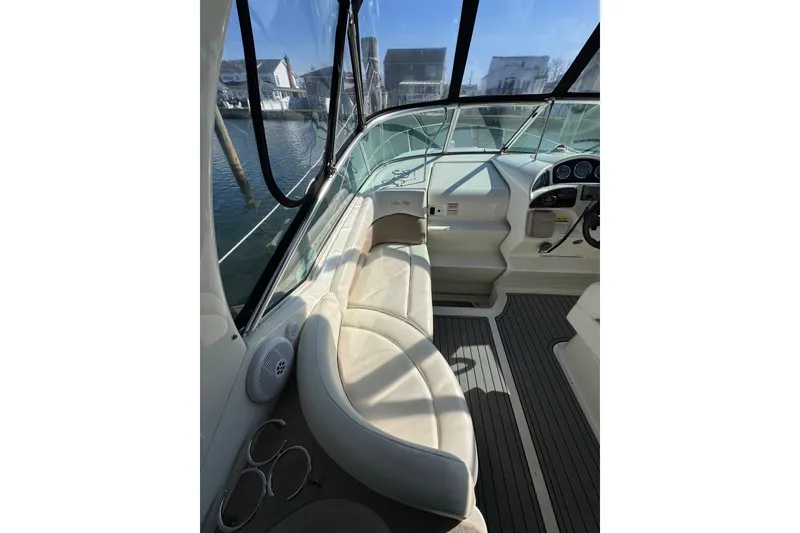 Slide: The Image of 2005 Sea Ray Sundancer 260 cockpit with beige seating and modern dashboard. - 9