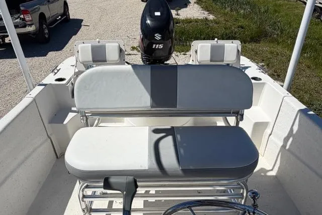 Slide: The Image of 2014 Carolina Skiff 218 DLV boat interior with seating and Suzuki 115 outboard motor. - 10