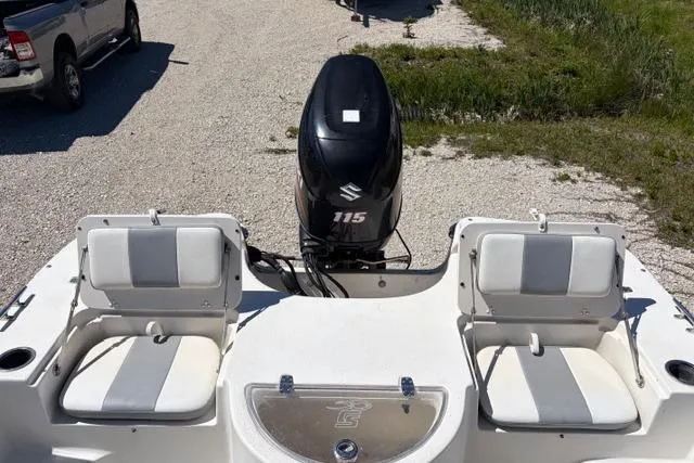 Slide: The Image of 2014 Carolina Skiff 218 DLV boat with Suzuki 115 outboard motor, featuring dual seating. - 13