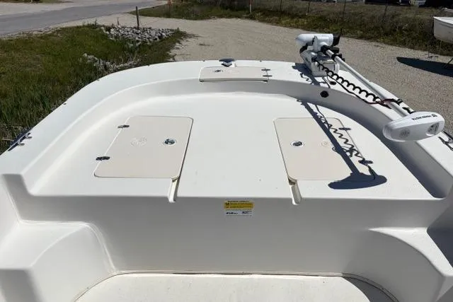 Slide: The Image of 2014 Carolina Skiff 218 DLV boat deck with storage compartments and trolling motor. - 2