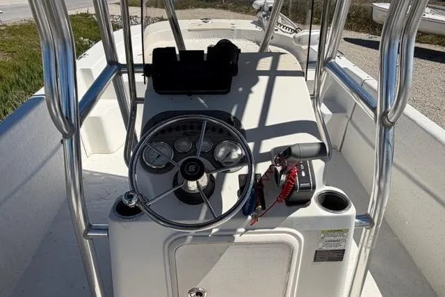 Slide: The Image of 2014 Carolina Skiff 218 DLV boat console with steering wheel and controls. - 9