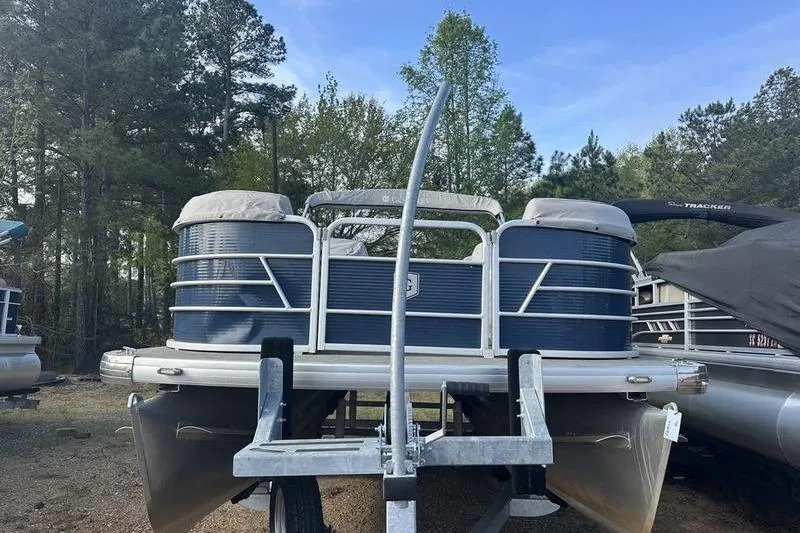 Slide: The Image of 2021 Godfrey Sweetwater 2186 C pontoon boat on trailer, surrounded by trees. - 11
