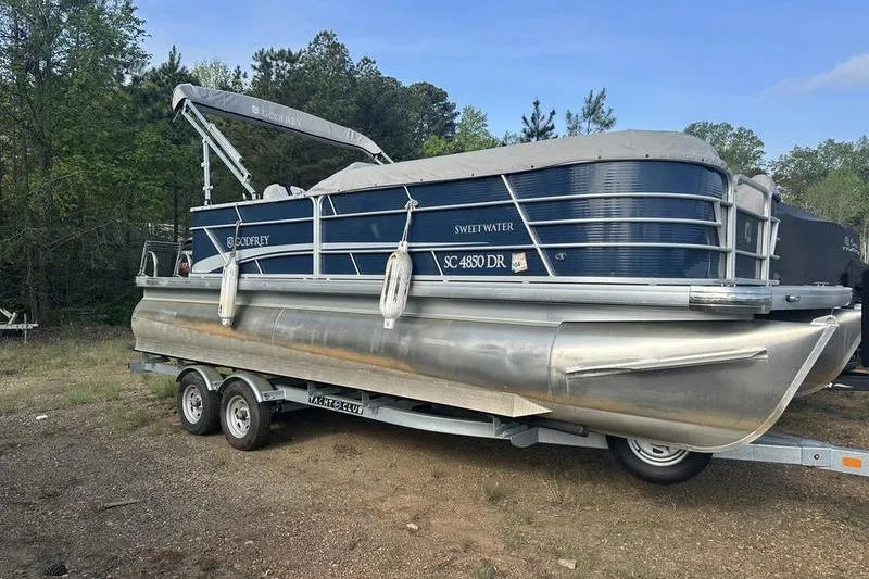 Slide: The Image of 2021 Godfrey Sweetwater 2186 C pontoon boat on trailer, parked outdoors. - 12