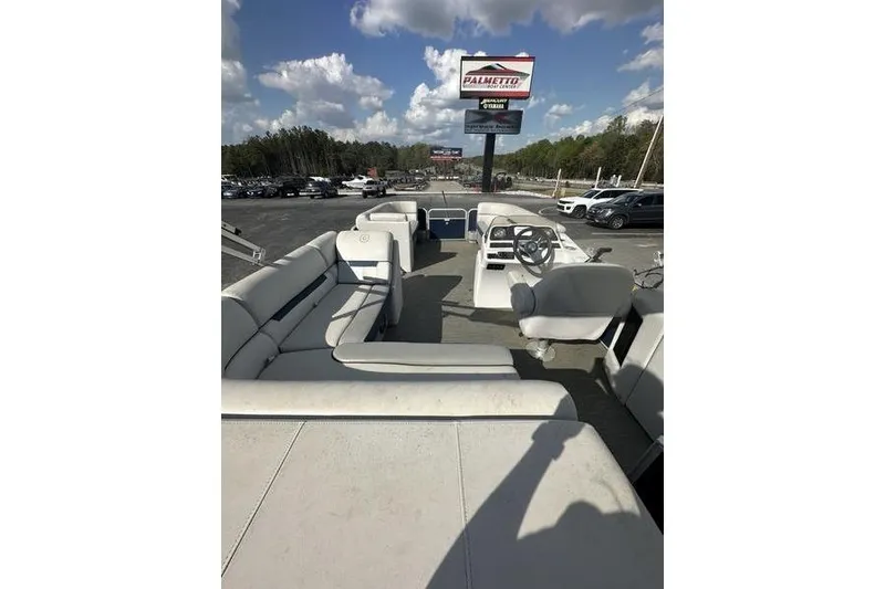 Slide: The Image of 2021 Godfrey Sweetwater 2186 C pontoon boat interior with seating and steering wheel. - 2