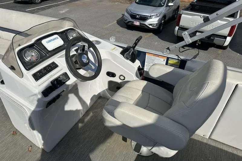 Slide: The Image of 2021 Godfrey Sweetwater 2186 C boat helm with steering wheel and captain's chair. - 9